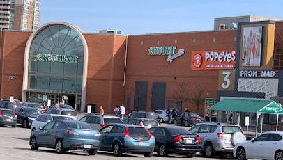 Exterior of a shopping mall showcasing a T&T supermarket and many cars in parking lot in Thornhill, Ontario